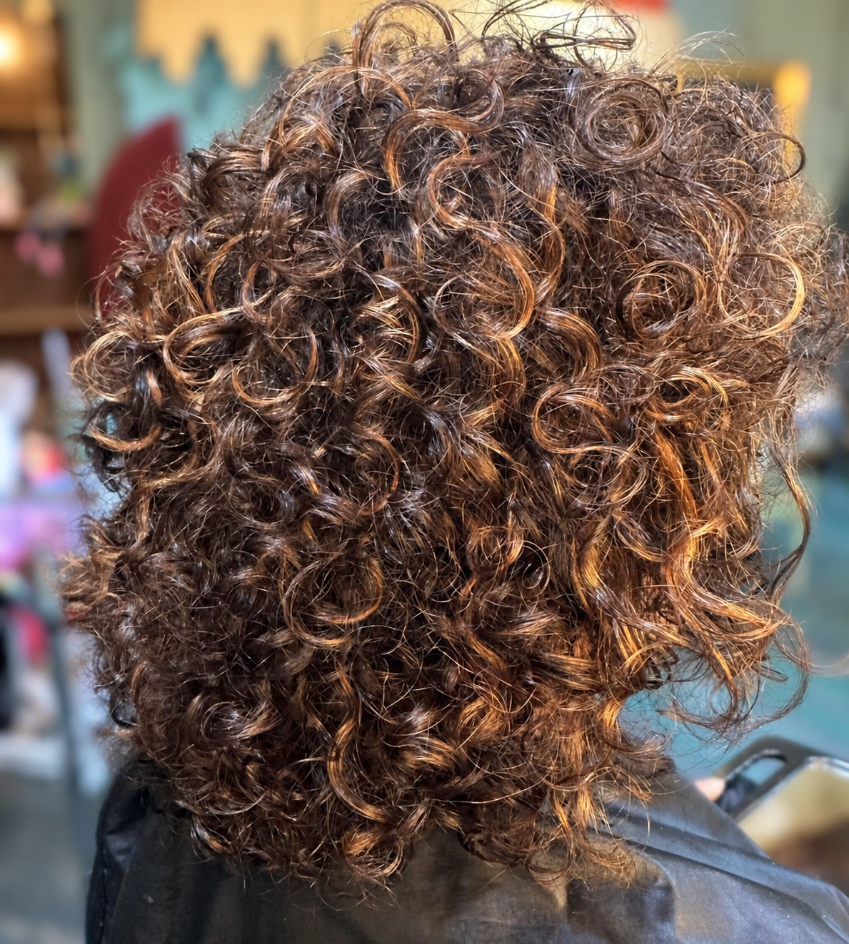 Defined brunette ringlets with warm highlights, by Kellie